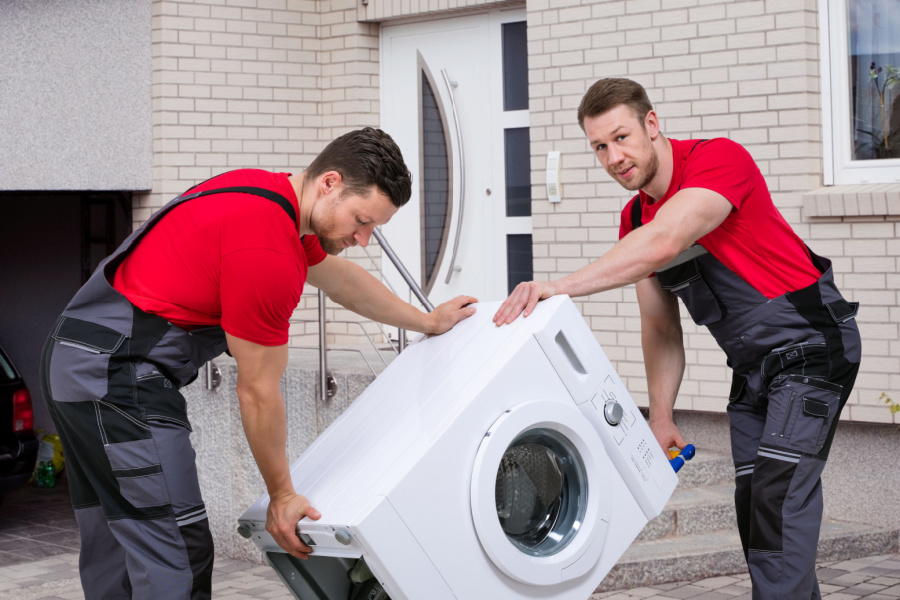 last mile delivery team with washing machine at customers house