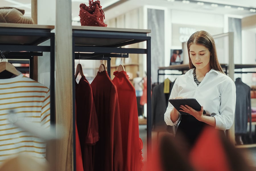 Clothing store owner checking her inventory